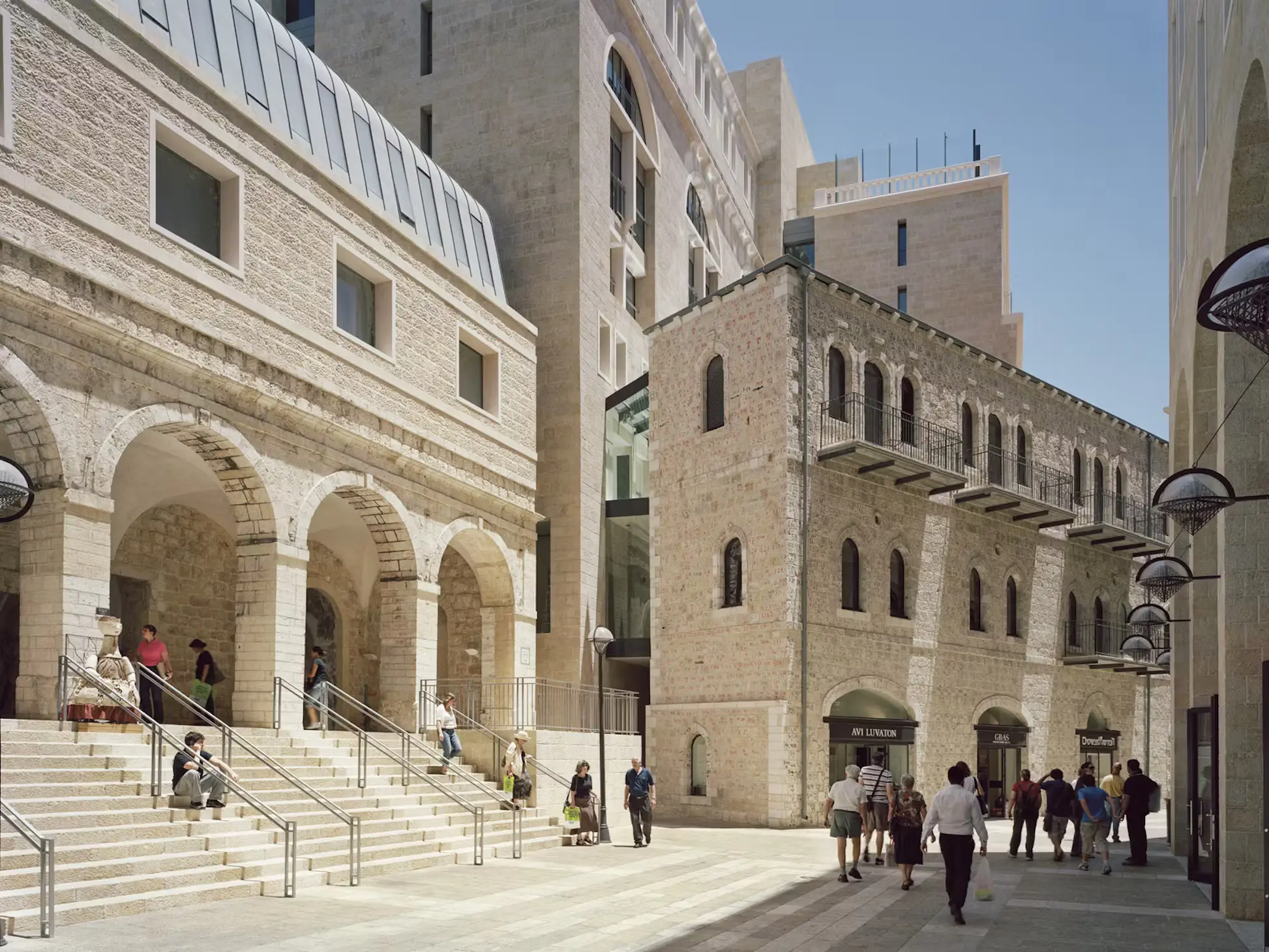 Mamilla plays a central role in Jerusalem by linking the old and new cities, and the Jewish and Arab quarters. Safdie’s plan for the area was approved in 1972; politics, litigation, and opposition by various groups delayed its completion until 2008. In addition to being one of the only places where the full range of Jerusalem’s population goes to shop, it is remarkable for its blend of contemporary architecture with historic buildings.