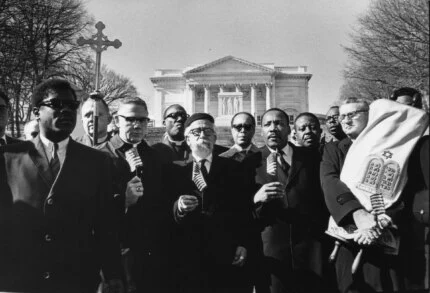 "Leaders of the protest, holding flags, from left: Bishop James Shannon, Rabbi Abraham Heschel, Dr. Martin Luther King, and Rabbi Maurice Eisendrath." Tomb of the Unknown Soldier, Arlington Cemetery, February 6, 1968.